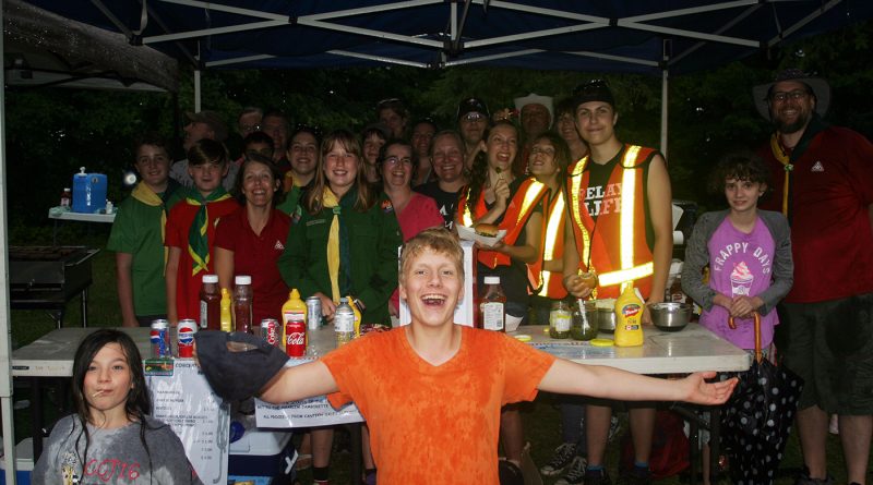 The First West Carleton Scouts and Ventures braved nasty weather to bring burgers to the masses. Photo by Jake Davies