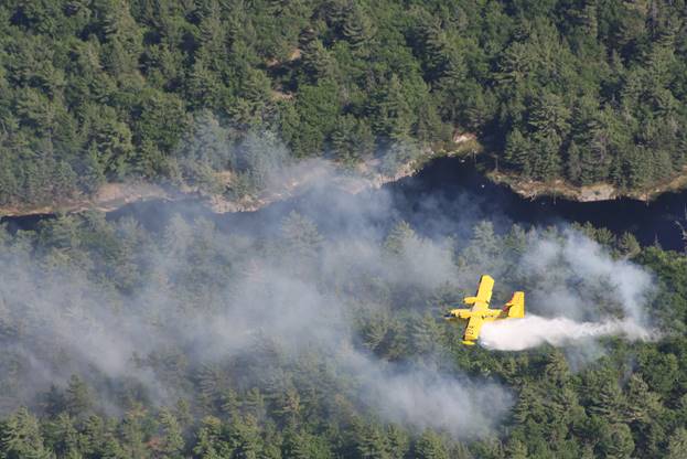 An MNR water bomber makes a run over a Renfrew County forest fire. Photo submitted