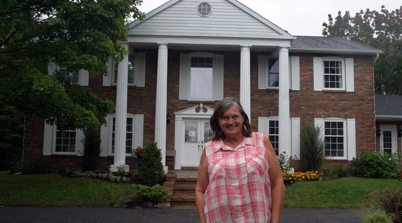 Owner Debbie Bernhardt poses outside of Windsong Manor in Corkery. Photo by Jake Davies