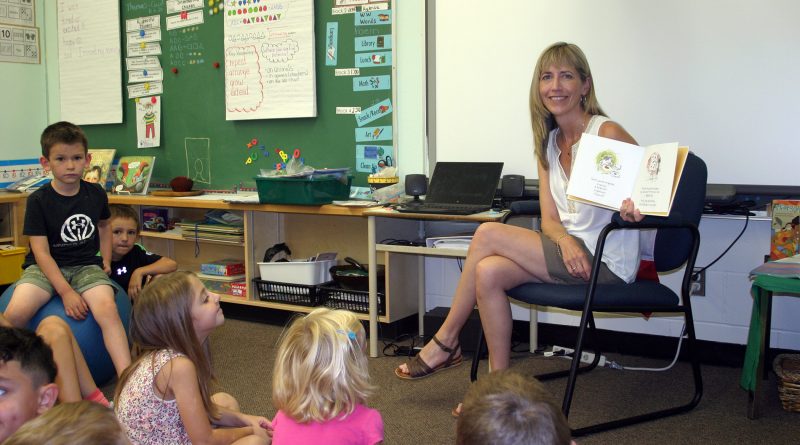St. Mike's new principal Penny Zorn reads to Kindergarten students. Photo by Jake Davies