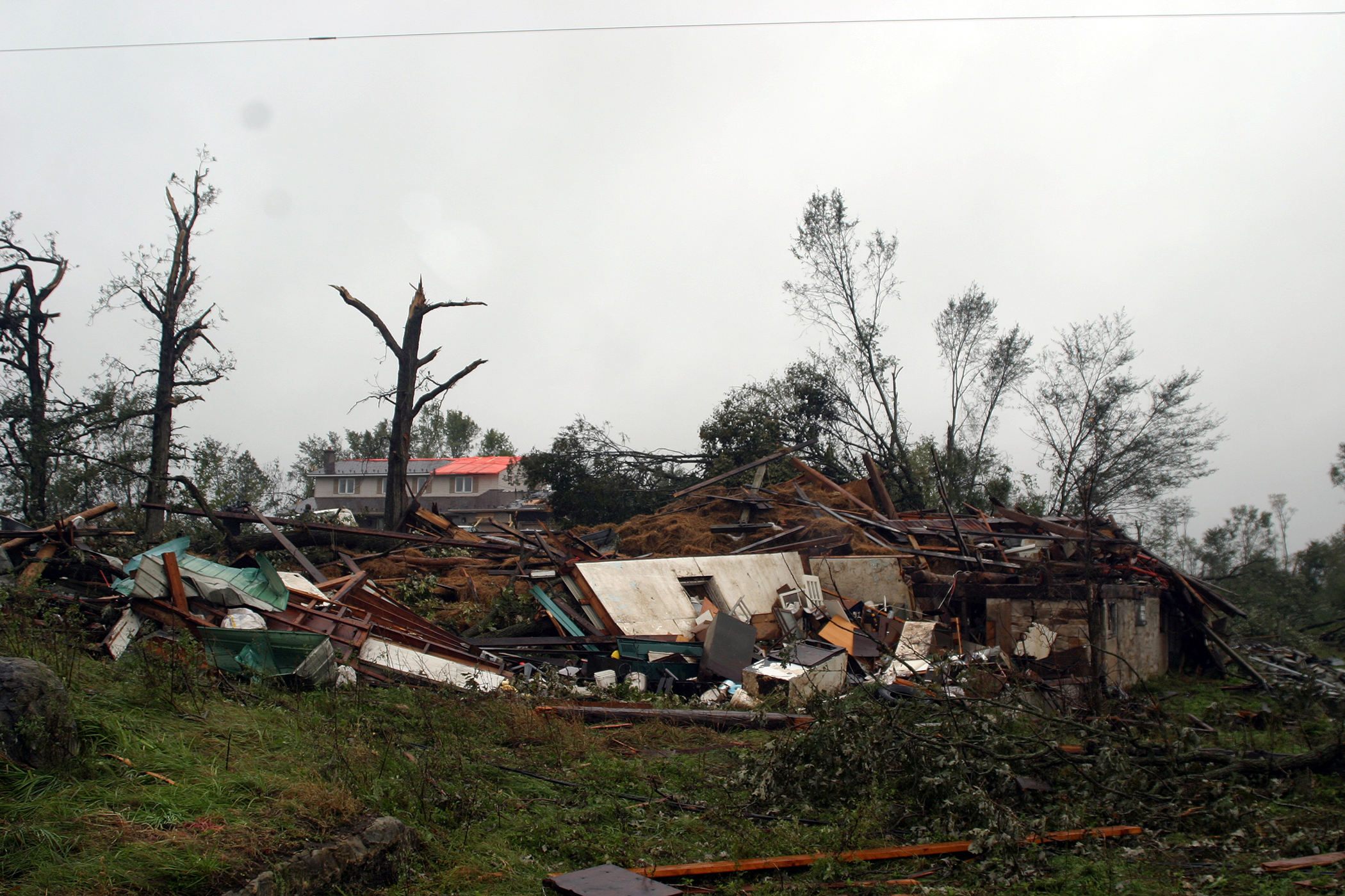 This was the stie of three barns, a silo and a two-acre maple tree forest on Woodkilton - all gone following Friday's tornado. Photo by Jake Davies