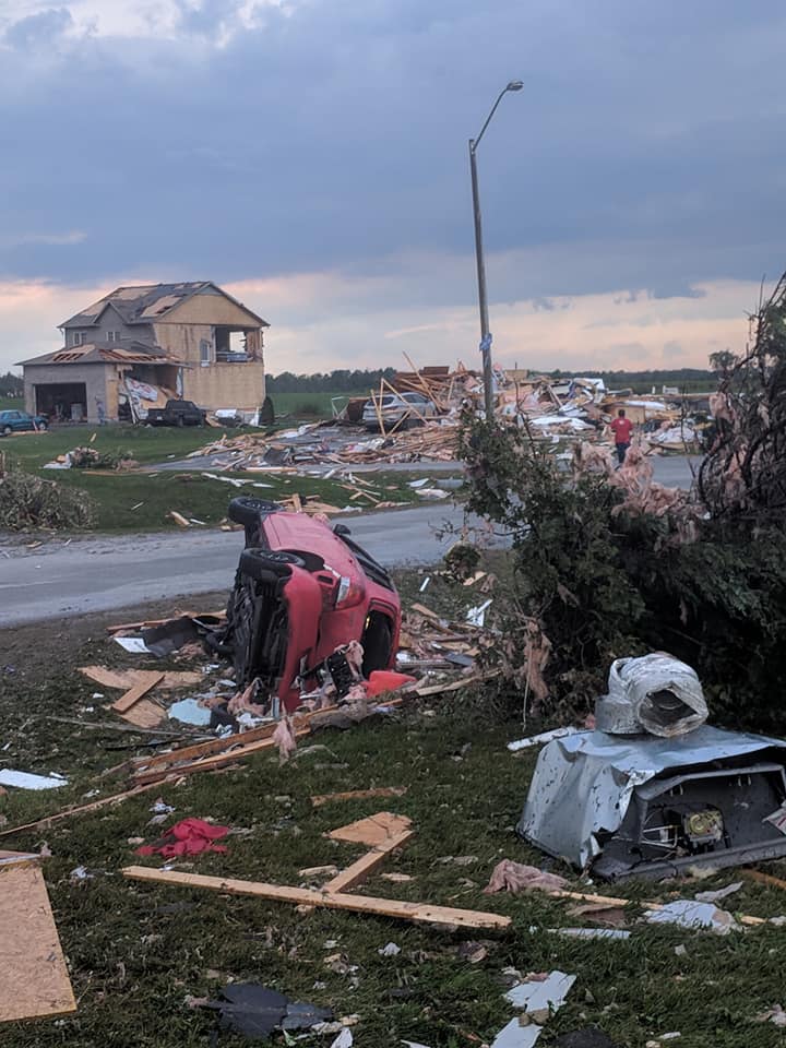 A car lies on its side after being flipped by a devestating tornado that touched down in West Carleton today. The Dunrobin strip mall was severly damaged forcing the closure of severa business. Photo by Nicole Novotny