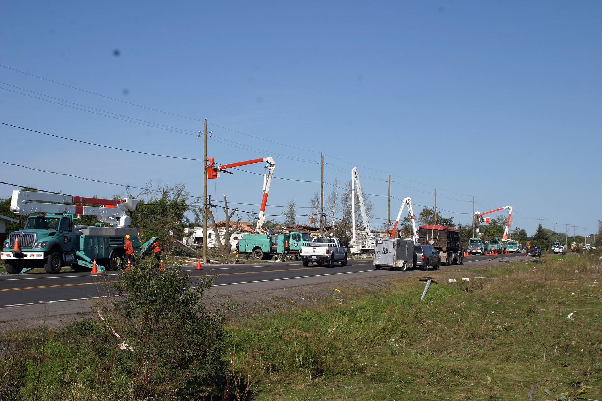 Hydro crews line the Dunrobin Side Road working hard to restore power to the neighbourhood. Photo by Jake Davies