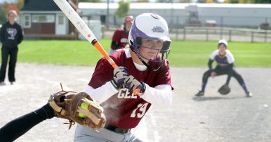 uOttawa Gee Gee player Megan DuPuis looks at a strike while Jen MacKay looks to get home from third. Photo by Jake Davies