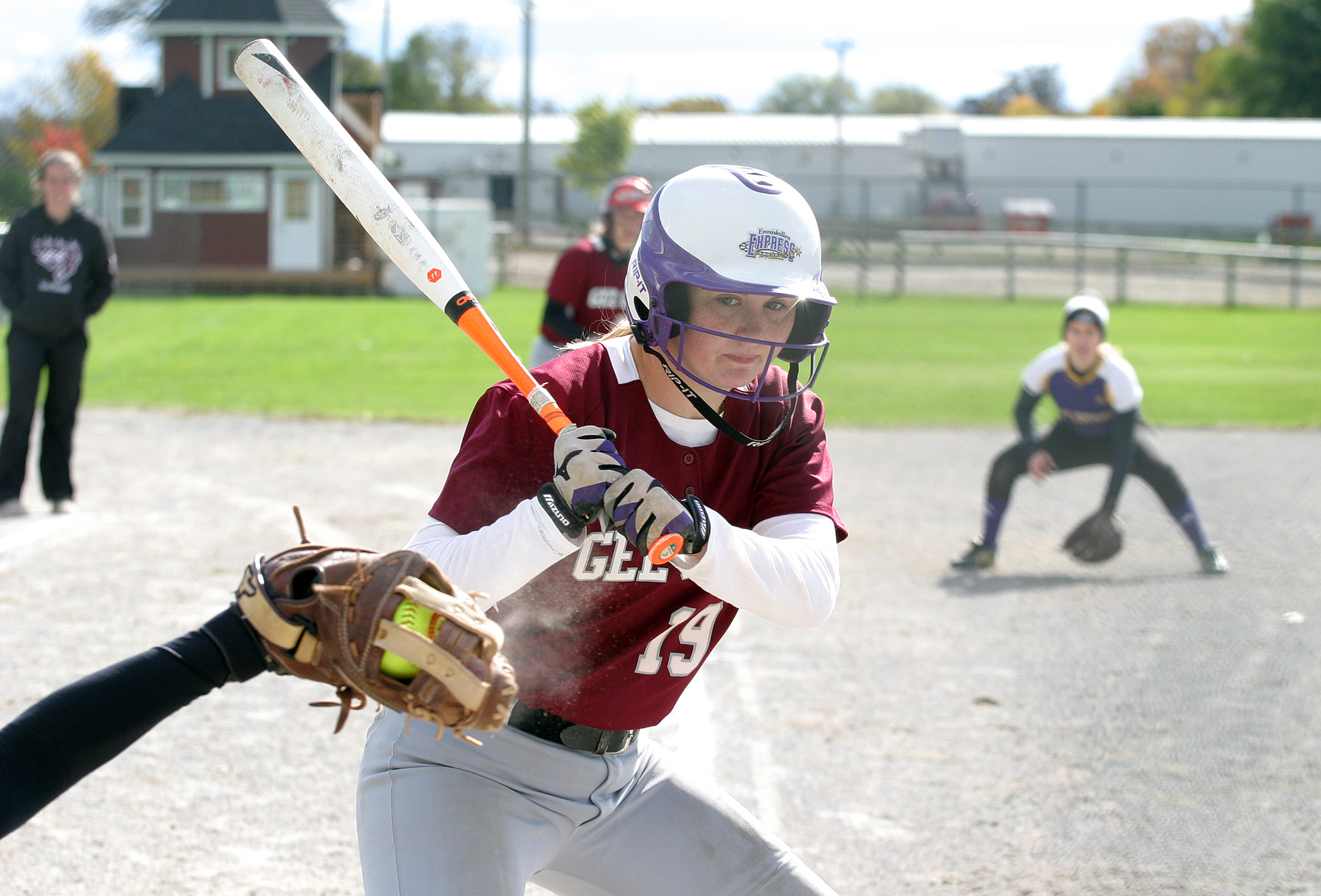 uOttawa Gee Gee player Megan DuPuis looks at a strike while Jen MacKay looks to get home from third. Photo by Jake Davies