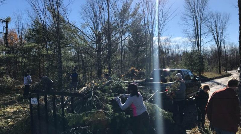 More than 20 volunteers were hard at 'er Sunday morning cleaning up six properties in the Dunrobin area. Photo courtesy Scott Hamilton