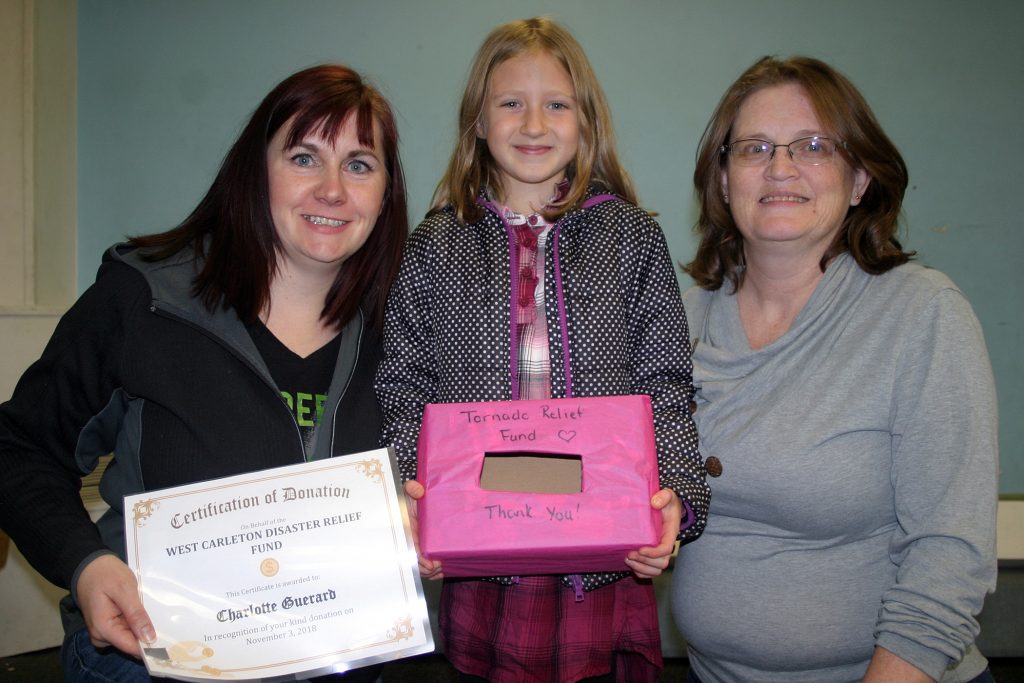 From left, WCDR's Lori McGrath, Charlotte Guerard and WCDR's Laurie Chauvin pose with the donation. Photo by Jake Davies