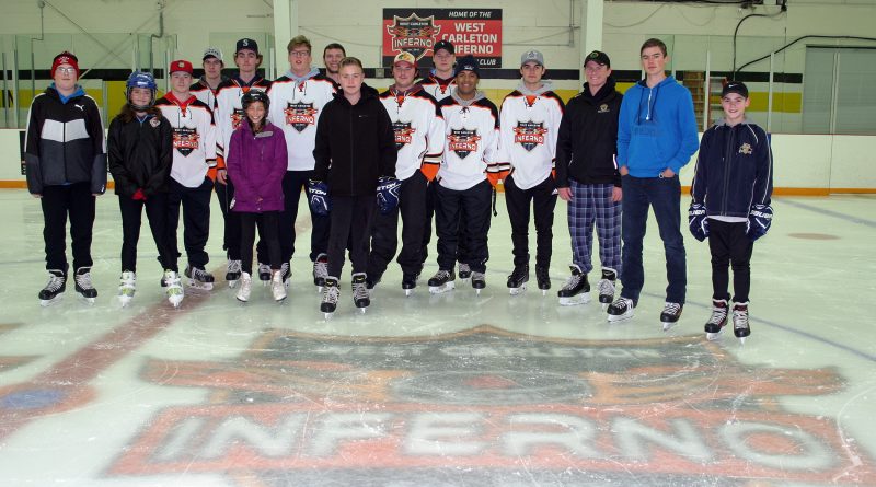 West Carleton Inferno players skate with some of their young fans during a community skate the team hosted Saturday. Photo by Jake Davies