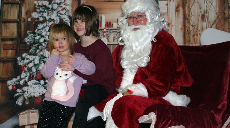 Santa talks with Piper, 2, and Braelyn, 7, Lesnick at Breakfast with Santa, Sunday last year. Photo by Jake Davies