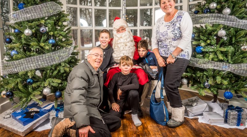 After the parade many headed to the Carp Commons Presentation Centre for a chance for a photo and heart-to-heart with Santa. In the photo Reid, Parker and Dawson Bishop sit with Santa along with grandparents Bill and Emily. Photo courtesy Michael Anderson Photography