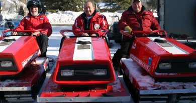 From left, Randy Heinle, Roy Taske and Bruce Schoblaska pose on their Red Diablos at the 13th annual Constance Bay Old Sled Run. Photo by Jake Davies