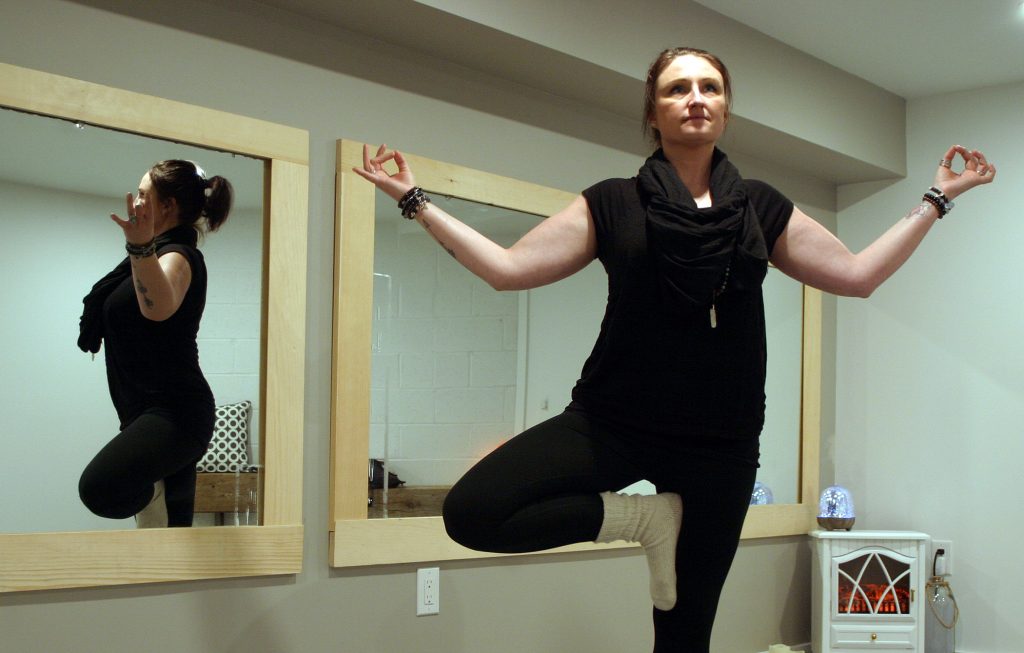 Tree Pose Yoga instructor Victoria Lefebre shows off her, what else, tree pose inside her new studio. Photo by Jake Davies