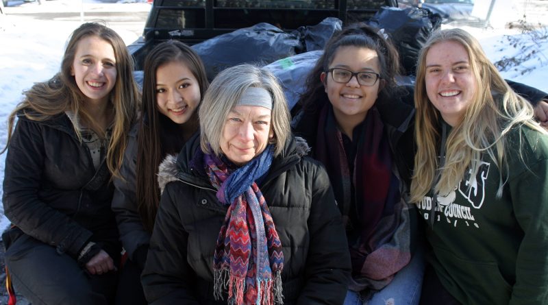 From left, WCSS students Michelle Gandelman, Sylvia Qi, Savvy Seconds' Vera Jones, Sam Sharp and Alicia Briggs pose with a truckload of donated clothes. Photo by Jake Davies