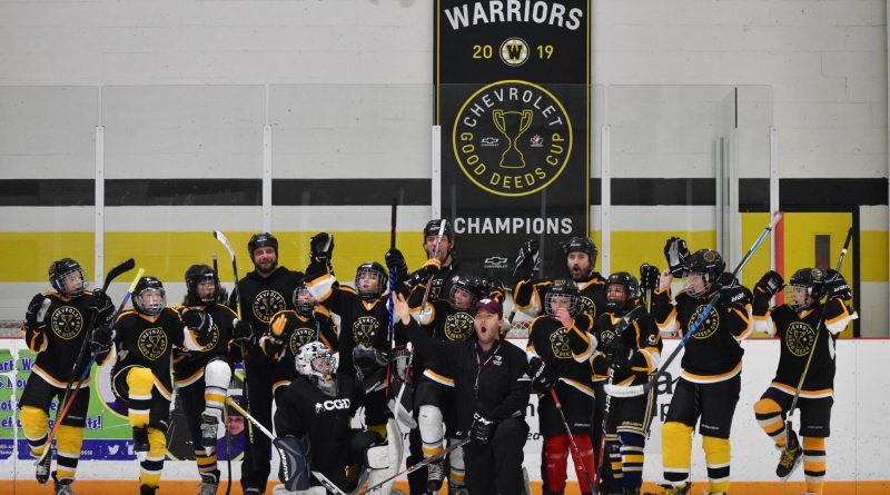 The Warriors pose for a photo with their banner yesterday, after a grueling practice run by uOttawa assistant coach and Carp native Brent Sullivan. Photo by Shelley Welsh