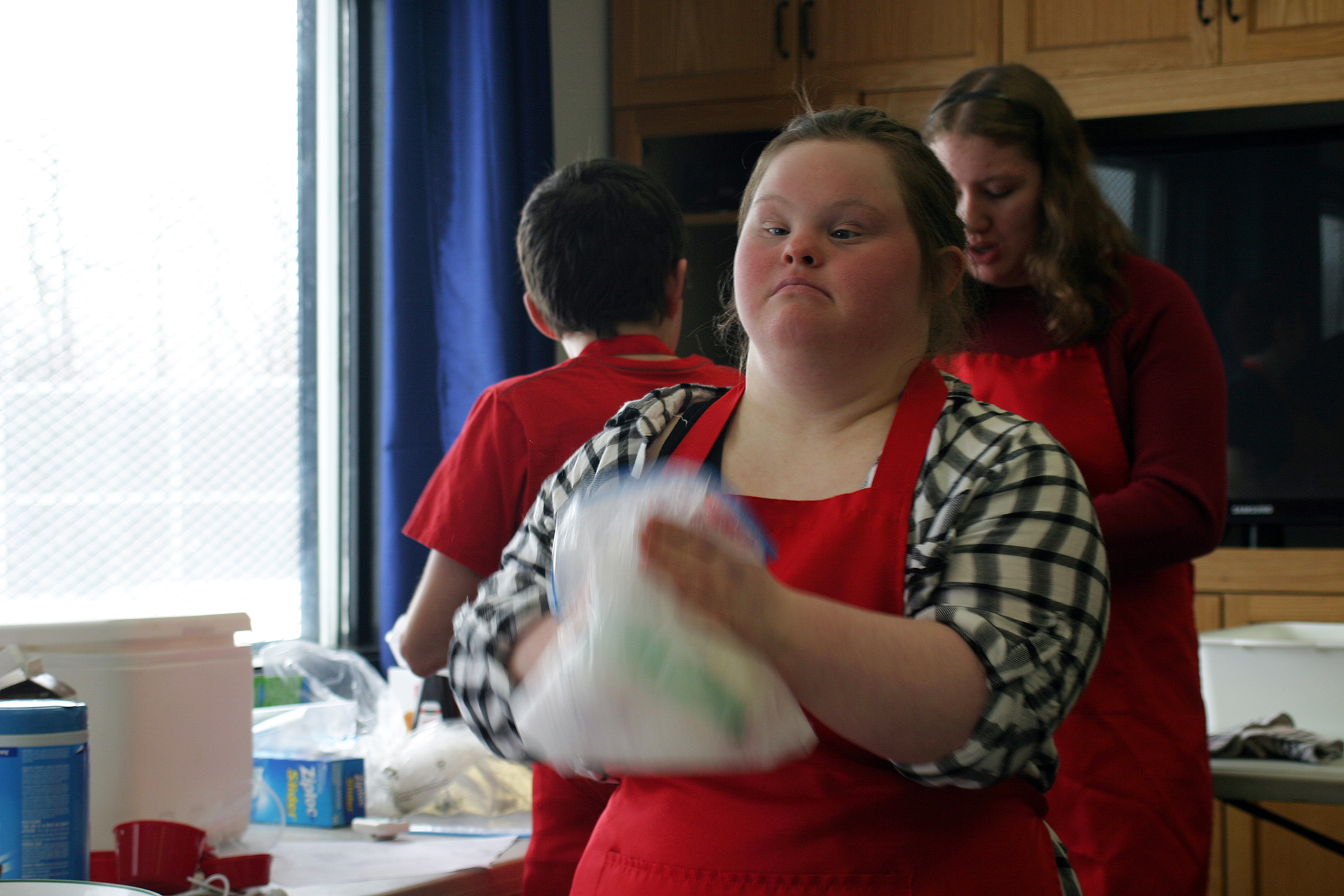 Ashley Innes shakes her freezer bag ice cream during the DCA's special needs cooking class last Sunday. Photo by Jake Davies