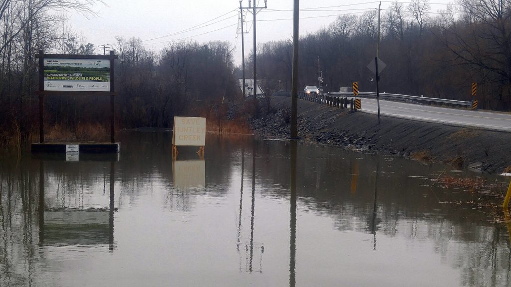 This section of Huntmar Drive is normally a dry, gravel-filled lot, but today the Huntley Creek has extended its reach. Photo by Jake Davies