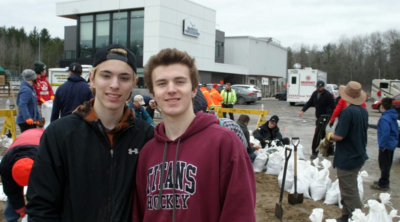 From left, WCSS students Jacob and Daniel Weedmark pitched in with about 30 other volunteers (around noon) to help fill sandbags at the Constance Bay communiy centre today. Photo by Jake Davies