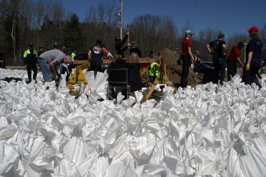 Thanks to a strong showing of volunteers yesterday and today, sandbag fillers were able to build up a surplus that had disappeared Saturday morning. Photo by Jake Davies﻿