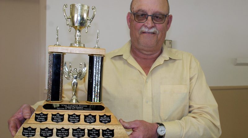 West Carleton Senior Council President Jim Wilson holds the West Carleton Seniors Oldest Participant Trophy awarded at the senior games. Photo by Jake Davies
