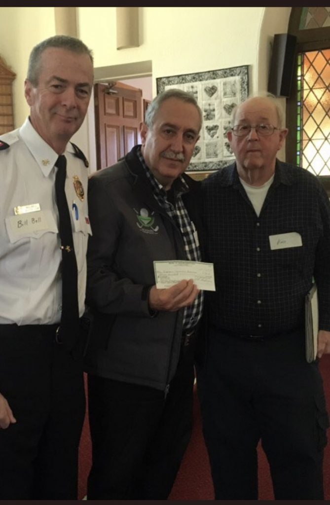 From left, District 6 Chief Bill Bell and Coun. Eli El-Chantiry receive a donation from the Men's Ministry's Ken Stewart. Courtesy El-Chantiry﻿