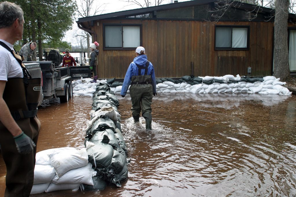 Volunteers work to save homes in Vydon Acres yesterday. Photo by Jake Davies