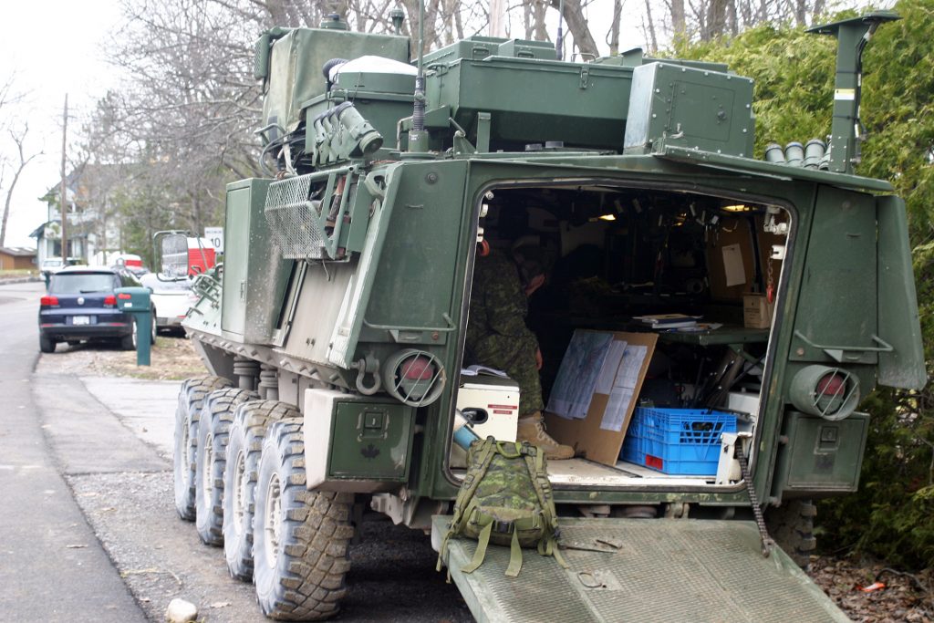 A soldier from Garrison Petawawa coordinates strategy from the back of a light armoured vehicle on Bayview Drive yesterday. Photo by Jake Davies