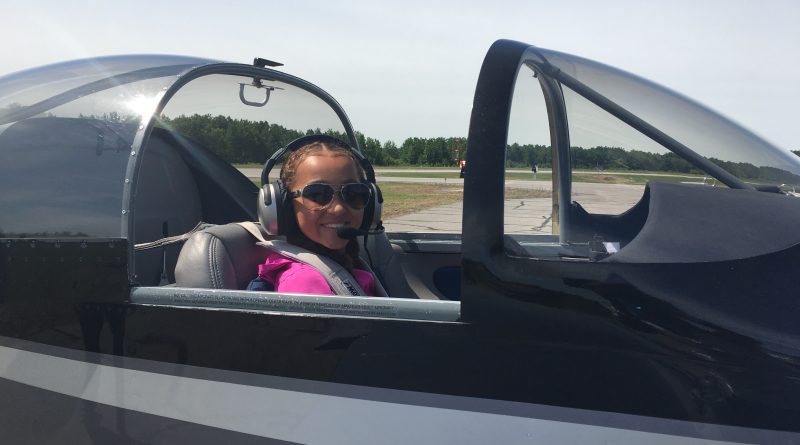 Young Eagle Audrey Anderson doing her best “Top Gun” impression after flying with Matt Pearson in his Vans RV7A. Courtesy EAA