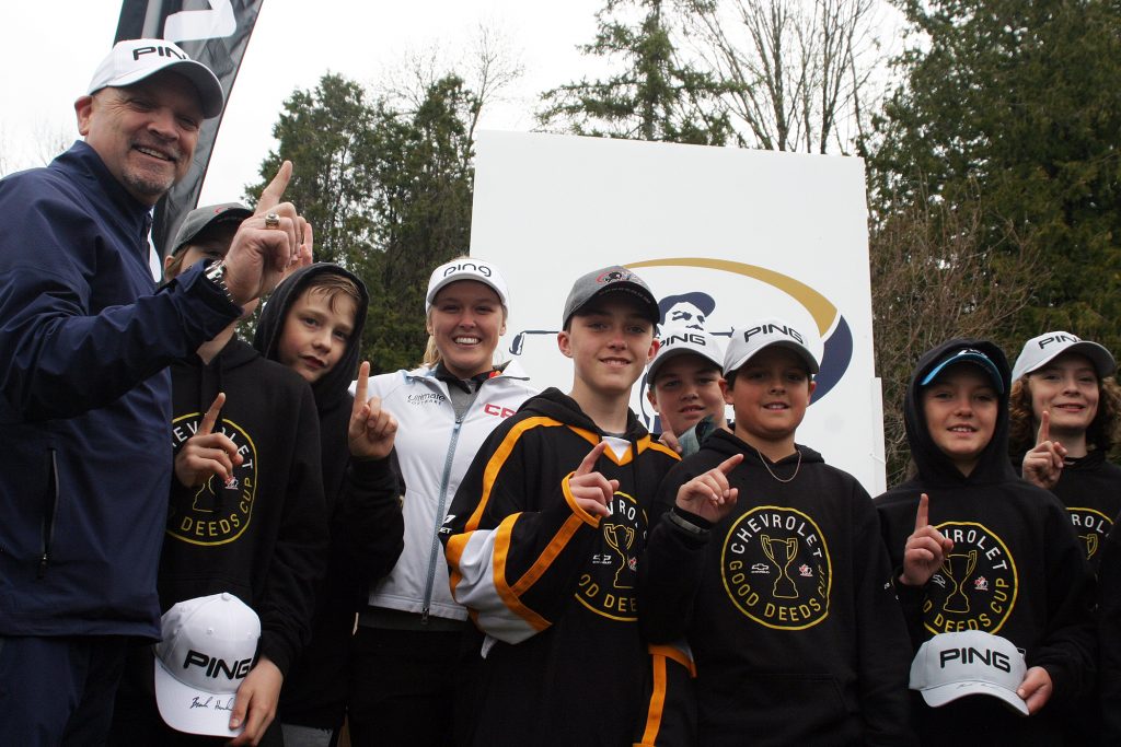Golf instructor, Tee It Up radio host and clinic emcee Kevin Haime, Brooke Henderson and the Good Deeds Cup winners - the West Carleton Warriors pose for a photo. Photo by Jake Davies