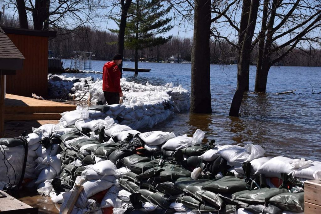 An Armitage Avenue resident checks his sandbag wall earlier this week. Photo by Shelley Welsh