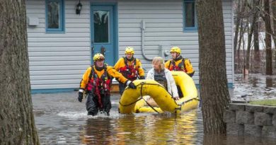 Lt. Paul Champion-Demers and his fellow Water Rescue technicians bring a resident to safety. Courtesy Wayne Cuddington / Postmedia