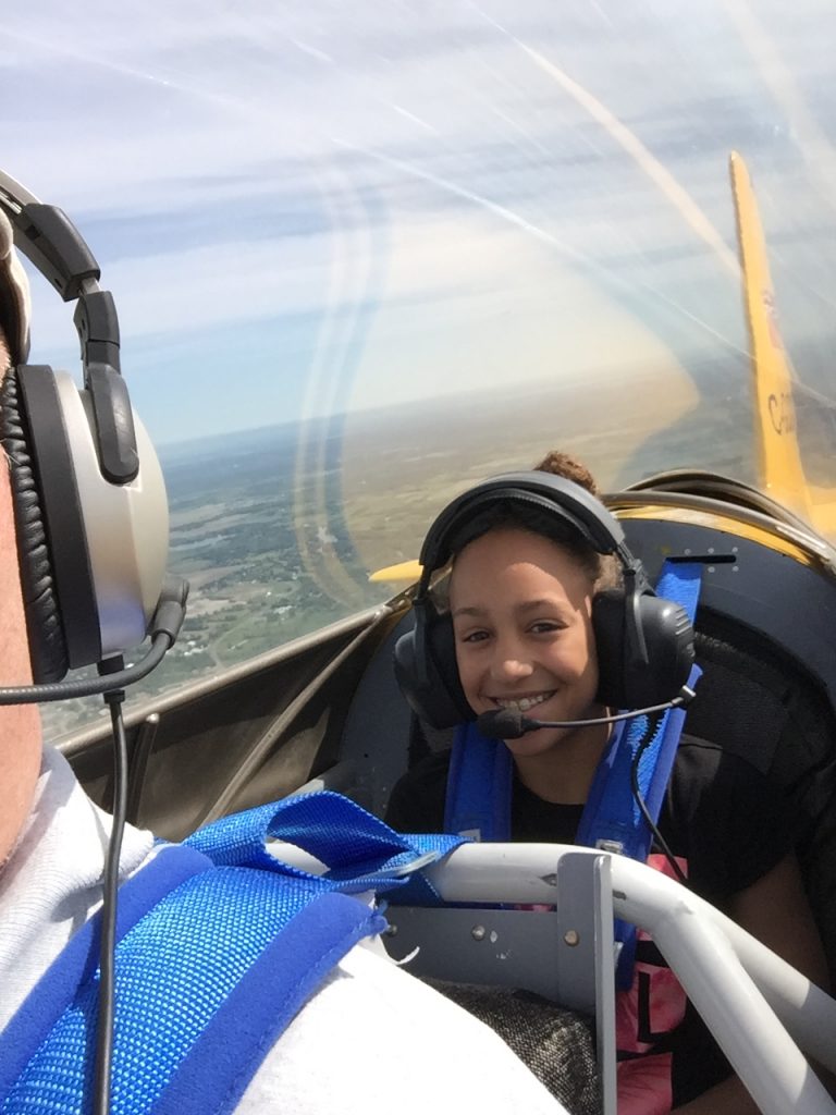 Young Eagle Savannah is all smiles as she experiences a flight in Chris Hepburn’s Vans RV8 aircraft last year. Courtesy EAA