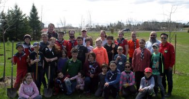The Seventh Kanata Scouts, and a few volunteers and neighbours, pose for a photo after planting 300 trees in Dunrobin. Photo by Jake Davies