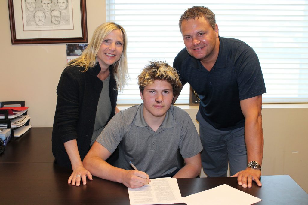 Proud parents Christine and Dale join their son Mason McTavish for a photo. Courtesy the Petes