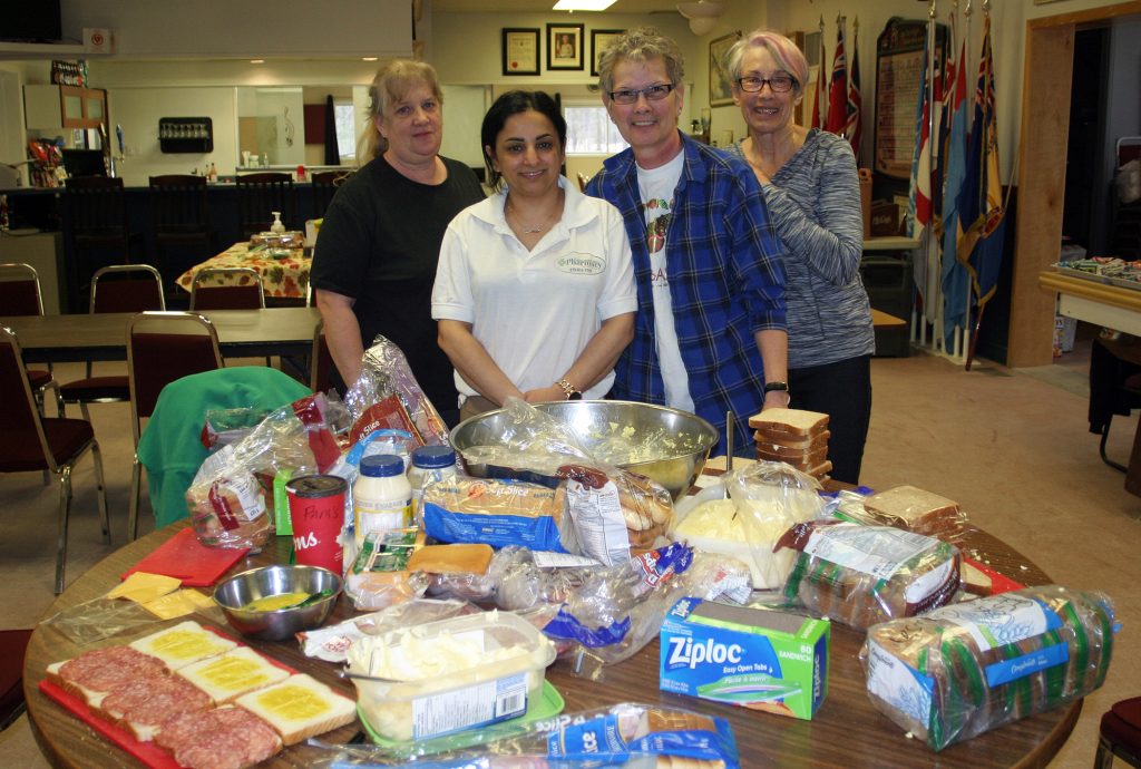 Volunteers from left, Pamella Taylor, Tamara Awada, Donna Kennedy and Joanne Ficker take a very short break from their food production work. Not photographed volunteer Lynda Boland. Photo by Jake Davies