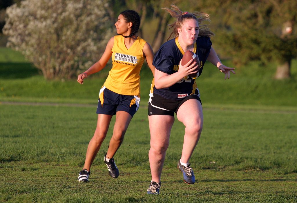 Wolverine receiver Abby Davis heads up field after making the catch. Photo by Jake Davies