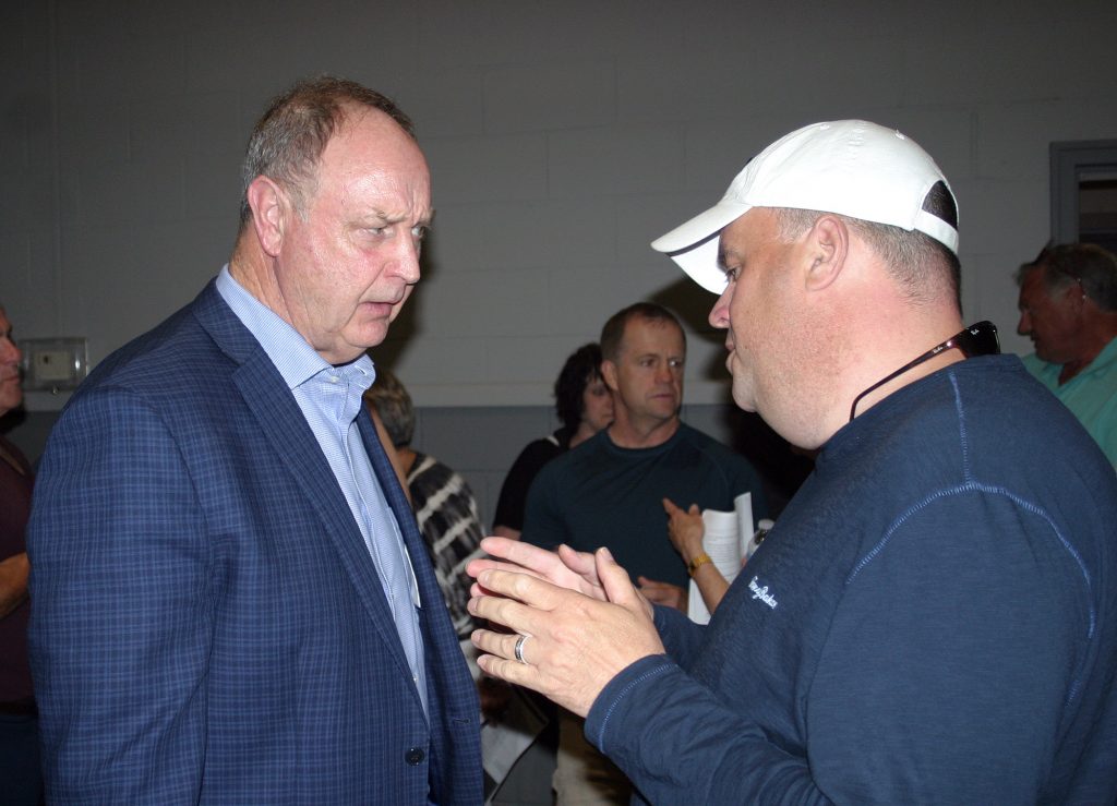 Minister of Natural Resources and Forestry, Renfrew-Pembroke-Nipissing MPP John Yakabuski, left, speaks with a resident following the official ending to yesterday's meeting. Photo by Jake Davies