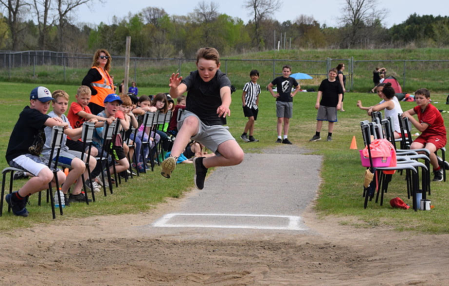 Blake Voelker leaps in the long jump competition. Photo by Shelley Welsh