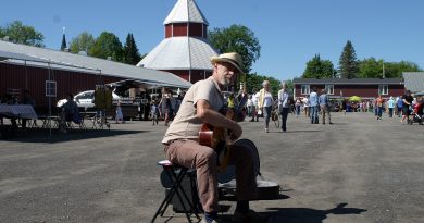 A man plays music at the Carp Farmers' Market.