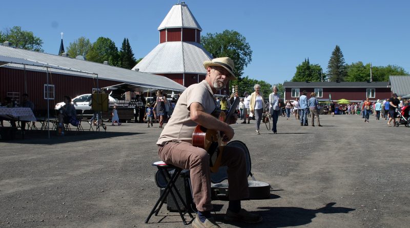 A man plays music at the Carp Farmers' Market.