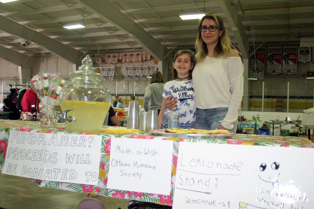 From left, Carp's Yael Shauer, 8, and her mom Irene used their both to raise money for the Ottawa Humane Society through their lemonade stand.. Photo by Jake Davies