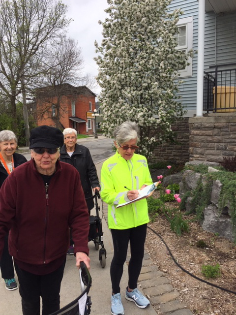 Three residents of Carp Commons Retirement Village helped to audit one of the routes, shown here at the side of the Carp Memorial Hall with volunteer Angela Quinlan. Photo by Dianne Breton 