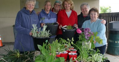 The Corkery Community Garden Club pose with their last customer of the day. From left, Carole Anne Parnell, Jackie Bassett, Marcia Bloom, MP Karen McCrimmon, Eillen Spinney and Iris MacPherson. Photo by Jake Davies