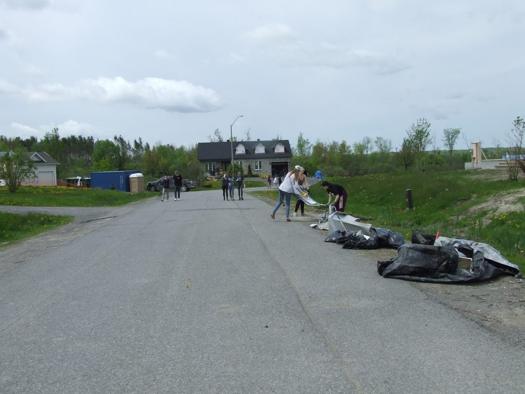 vThe road was full of debris by the time the students were done working. Photo by Lori McGrath