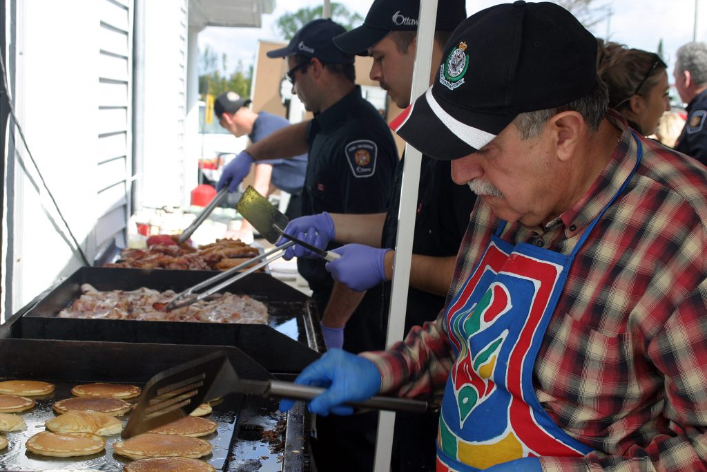 Chef Coun. Eli El-Chantiry adds his expertice to the grill at the Dunrobin firefighters' breakfast. Photo by Jake Davies﻿