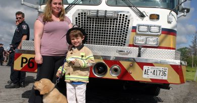 Jessica and Hunter Woods with 12-week-old Finnagin look ready to join the Station 66 team at Dunrobin's firefighter breakfast last week. Photo by Jake Davies