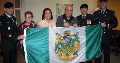 From left, Master Warrant Officer Chris LeBlanc, WCDR's Angela Bernhardt, WCDR's Shannon Todd, Coun. Eli El-Chantiry, Major Kevin Wong and firefighter Paul Asmis pose with West Carleton's township flag. Photo by Jake Davies