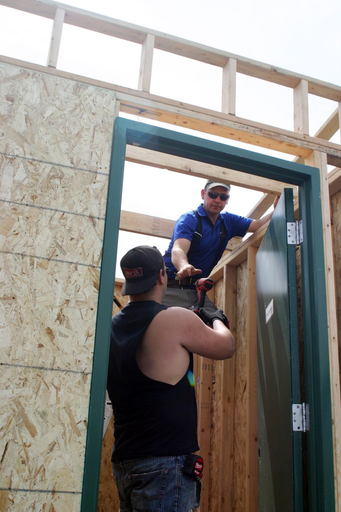 Senstar vice president and COO Jeremy Weese works on a new wquipment shed for the ball fields. Photo by Jake Davies