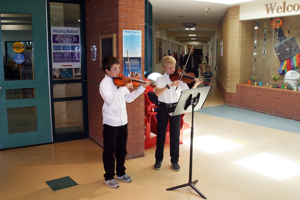 Guests were serenaded by two young violists as the arrived for Stonecrest's graduation ceremony. Photo by Jake Davies