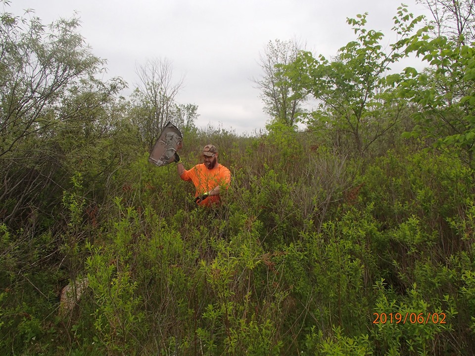 Gatineau's Tim Hayes escapes the bush with some tornado debris Sunday. Courtesy Ruth Sirman