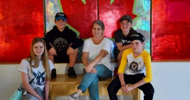 Artist Sarah Moffatt, posing with some West Carleton Warriors Good Deeds champs, made this beautiful Canada Flag especially for Light Up Dunrobin. Photo by Shelley Welsh